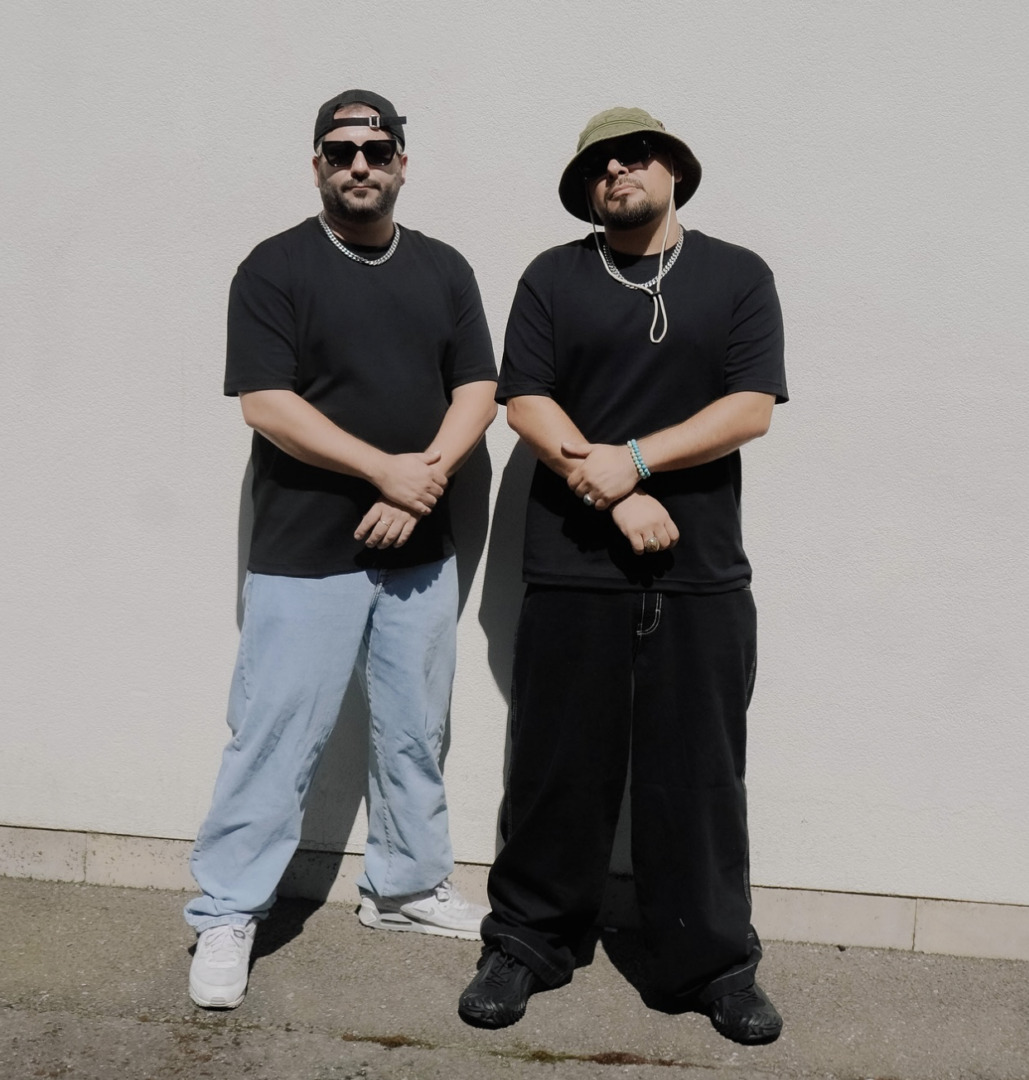 Jaded posing together in the summer sun agianst a white wall
